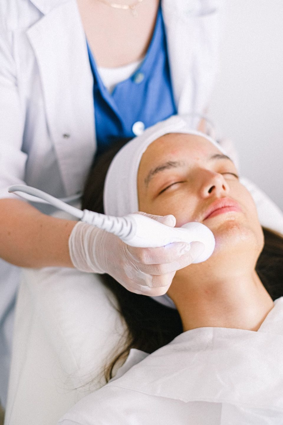 Esthetician performing a facial treatment on a client